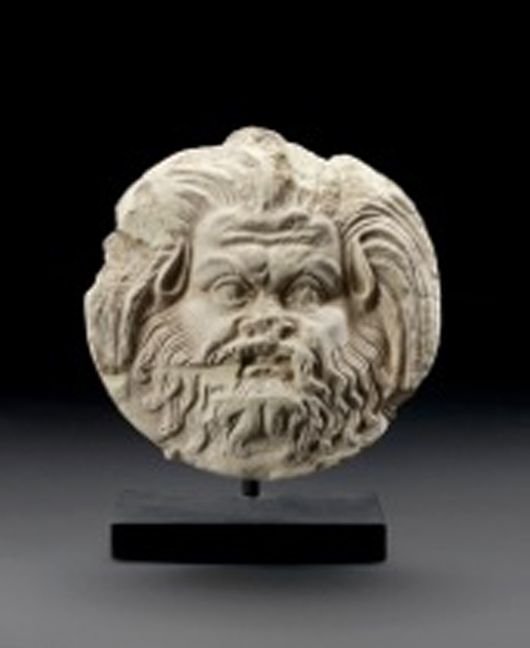 This fifth-century B.C. terracotta circular antefix, decorated with the head of a satyr, is priced at £2,800 ($4,400) in Charles Ede's Christmas antiquities catalog. 